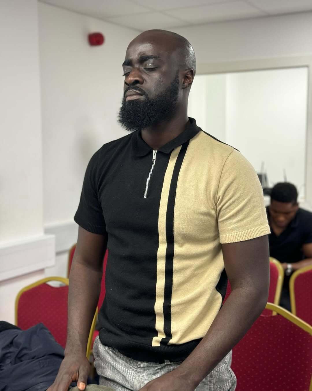 Man praying in church congregation